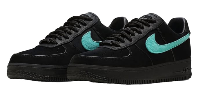 View of black and blue Nike Air Force 1 shoes.